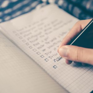 hand written checklist in notebook